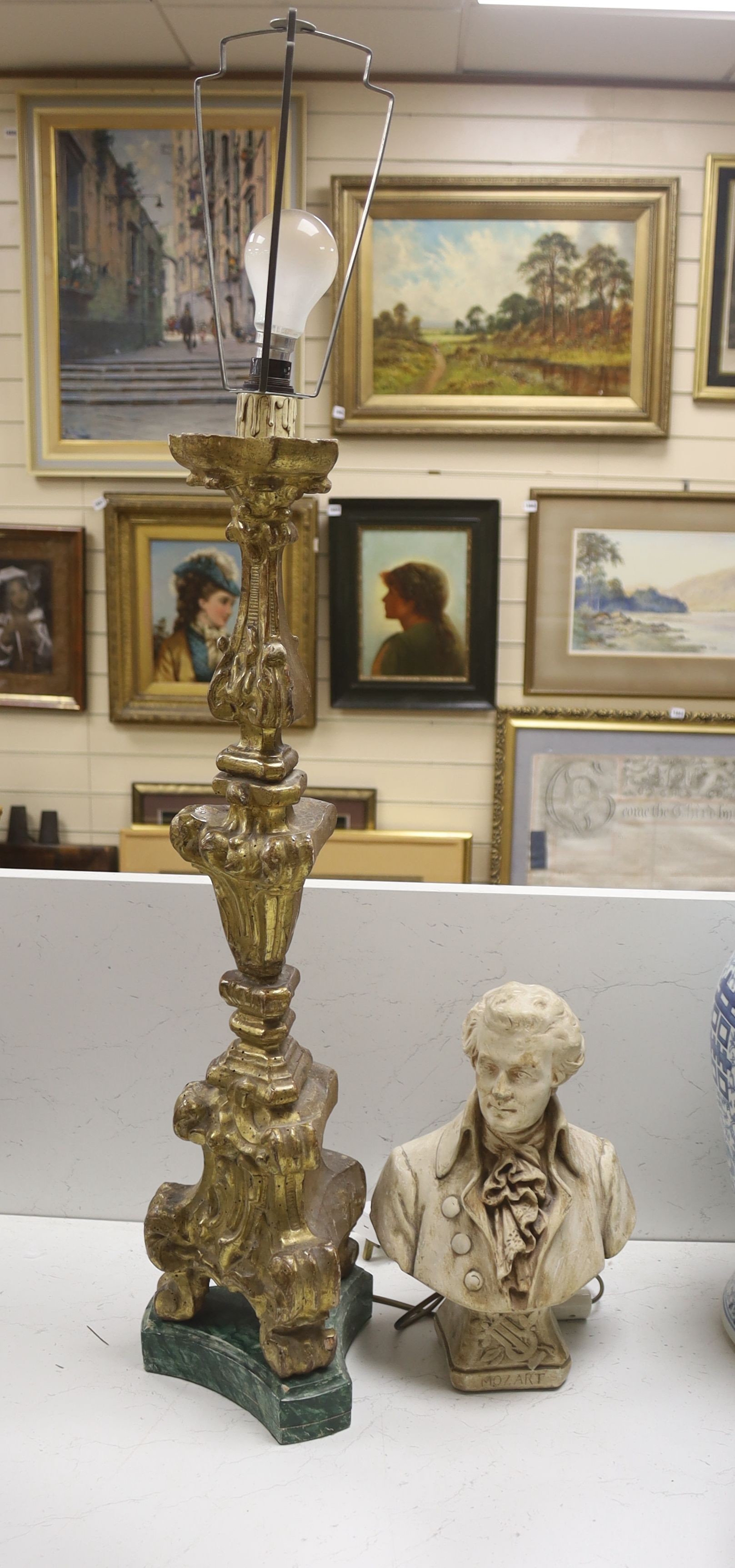 A giltwood altar candlestick as a lamp, height 71cm (excl. light fitting) and a plaster bust of Mozart